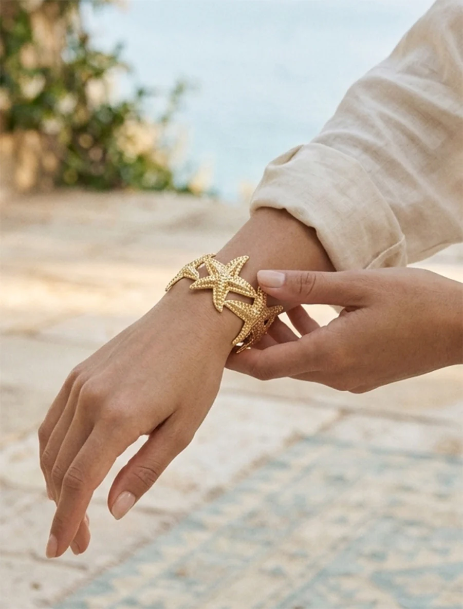 Open armband zeesterren - Goud